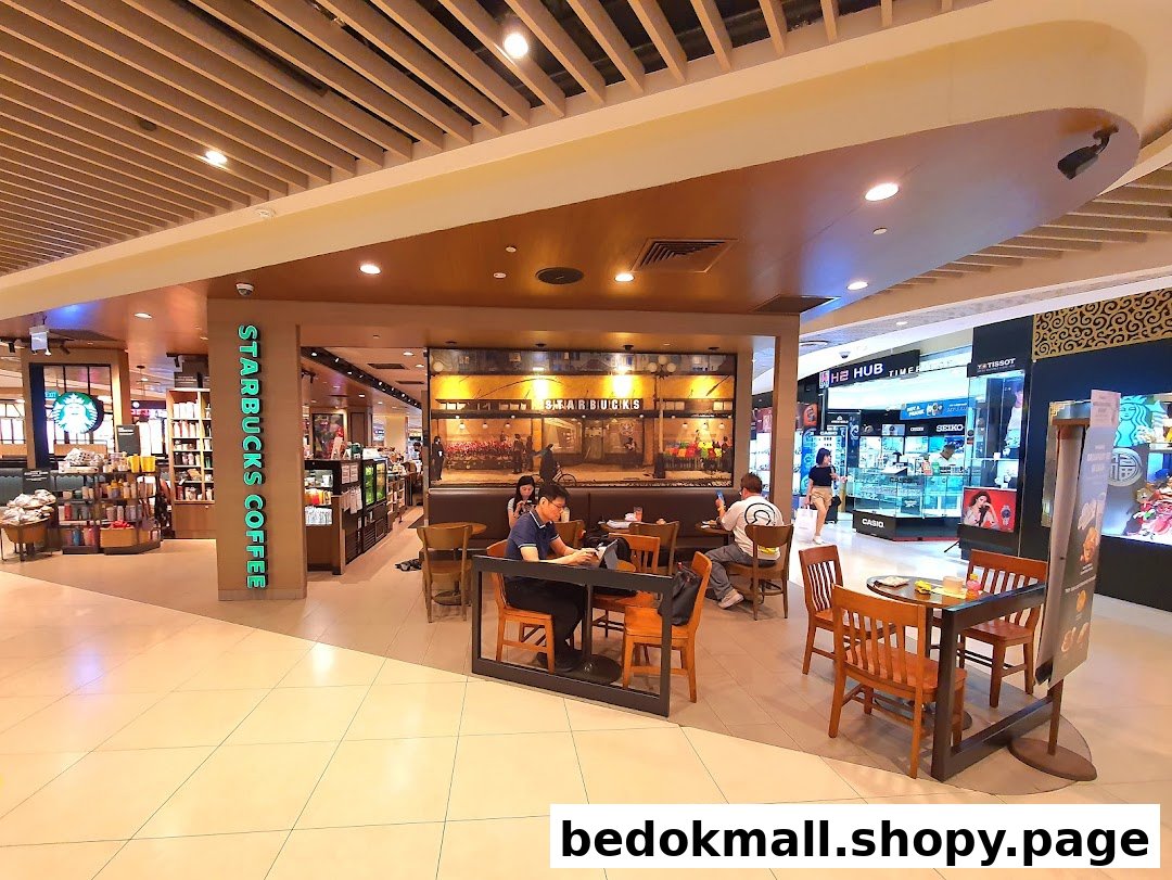 Starbucks shop interior with customers and seating area in a mall.