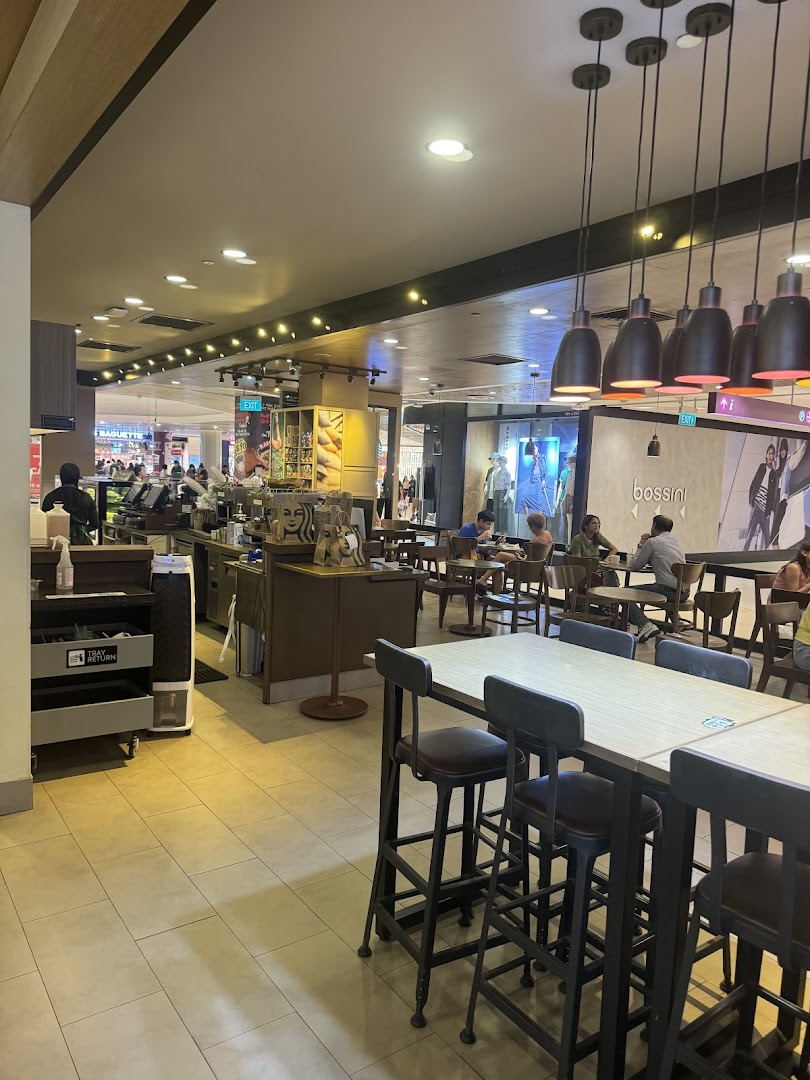 Starbucks interior with counter, seating area, and customers.