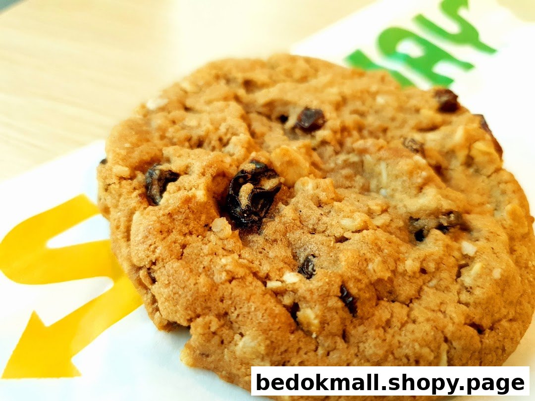Close-up of a cookie with the Subway logo visible in the background.