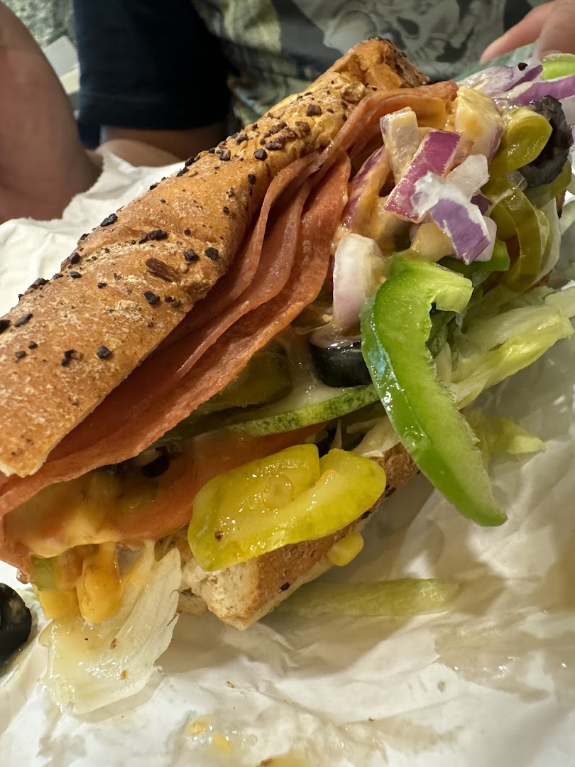 Close-up of a Subway sandwich with various toppings and ingredients.