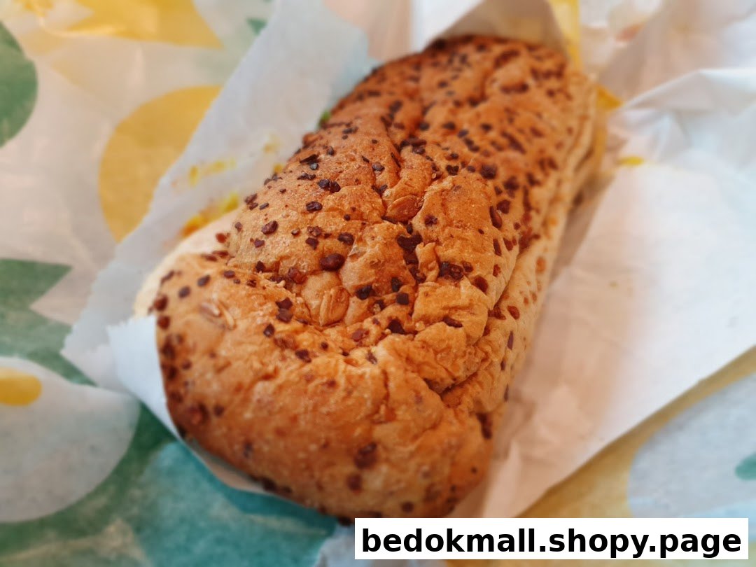 A Subway sandwich wrapped in branded paper.