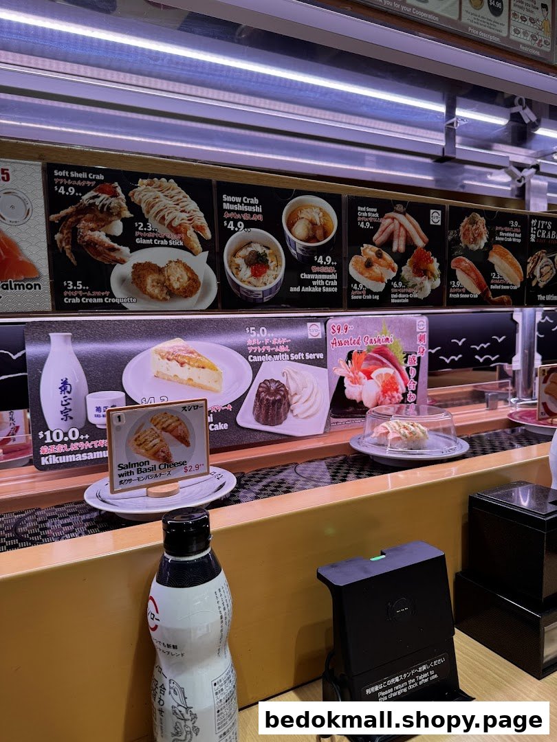 Conveyor belt sushi restaurant interior with food items and menu displays.