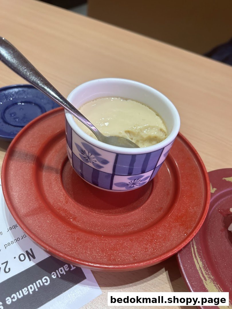 A close-up of a creamy dessert or custard in a bowl with a spoon.