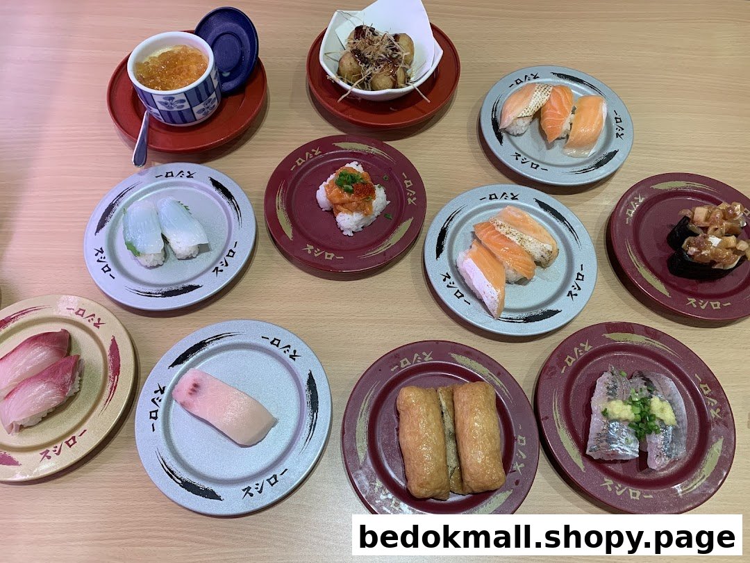 Various plates of sushi and Japanese dishes on a wooden table.