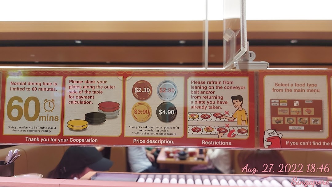 Instructional signs and plate pricing visible in a restaurant setting.