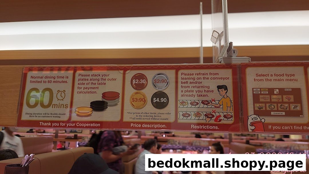 A sign displaying dining rules and plate prices in a sushi restaurant.