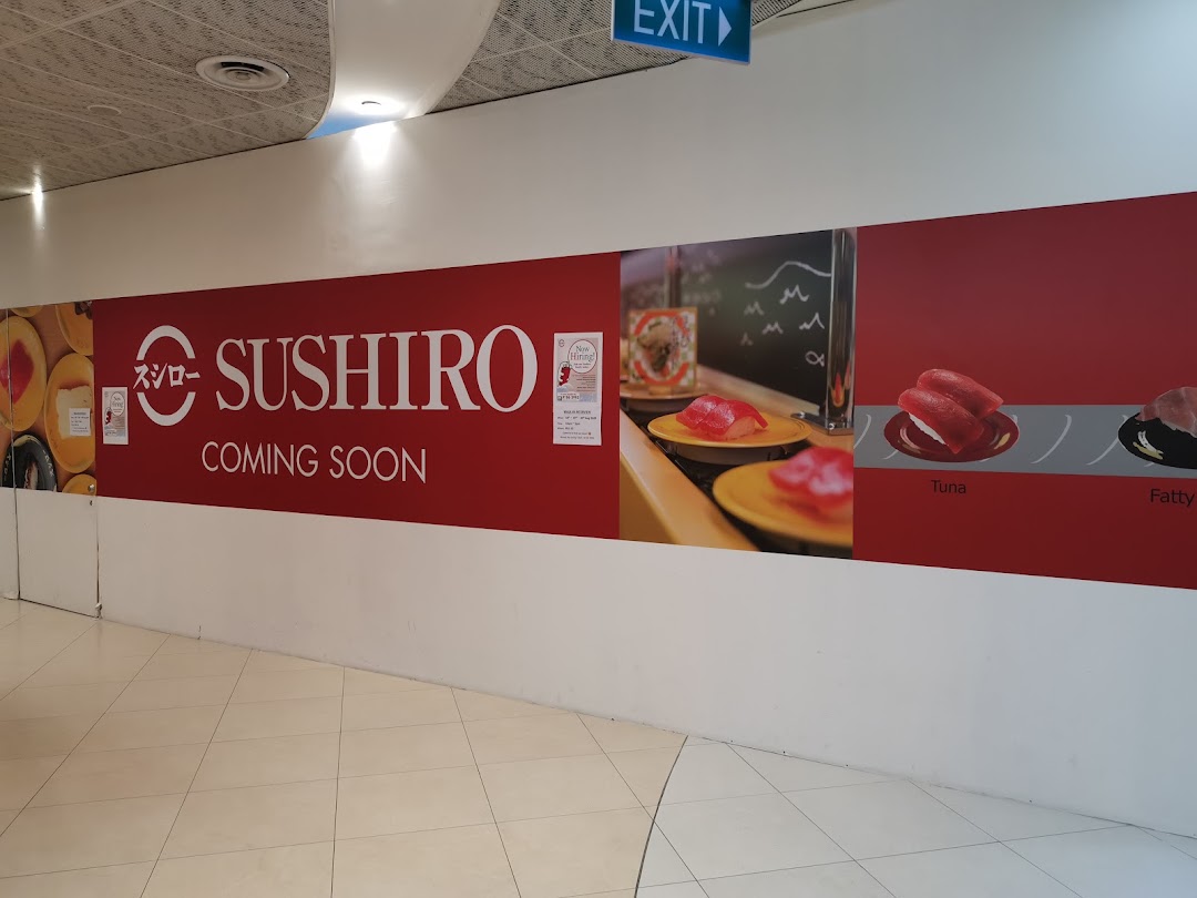 Sushiro 'coming soon' banner with sushi images on a mall wall.