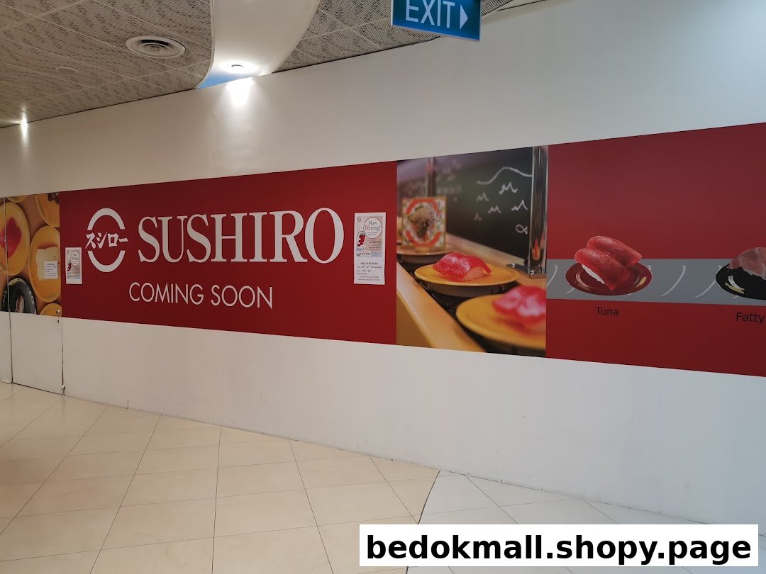 Sushiro 'coming soon' banner with sushi images on a mall wall.