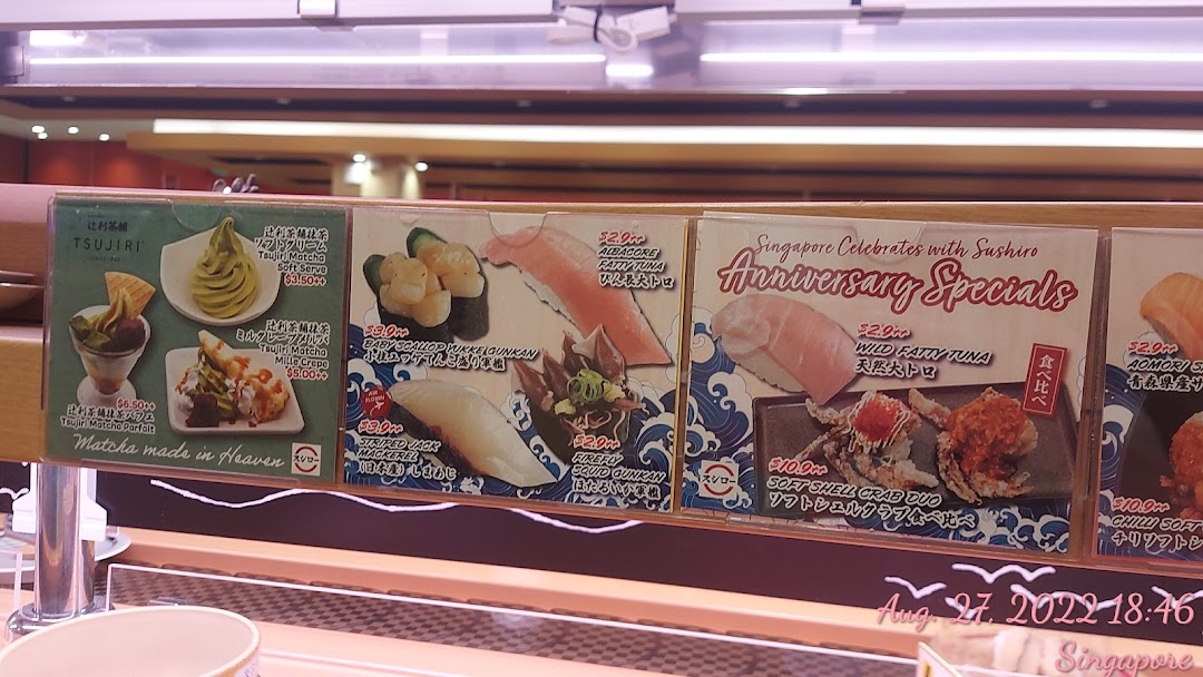 Display boards showing various food items, prices, and specials at a restaurant.