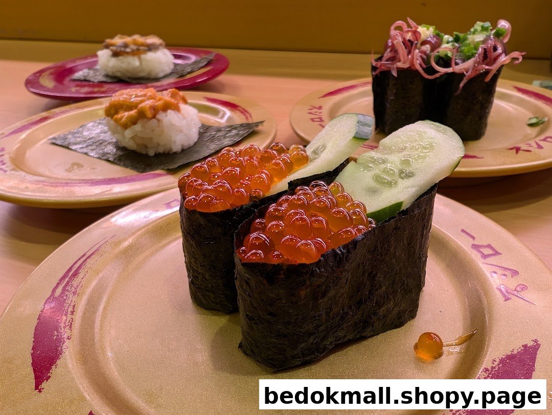 Close-up of various sushi dishes on plates in a restaurant setting.