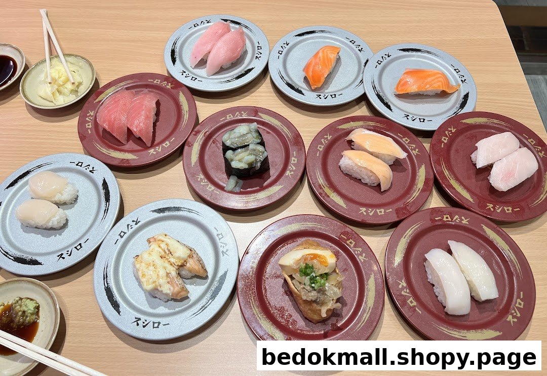 Various plates of sushi and other dishes on a table at Sushiro.
