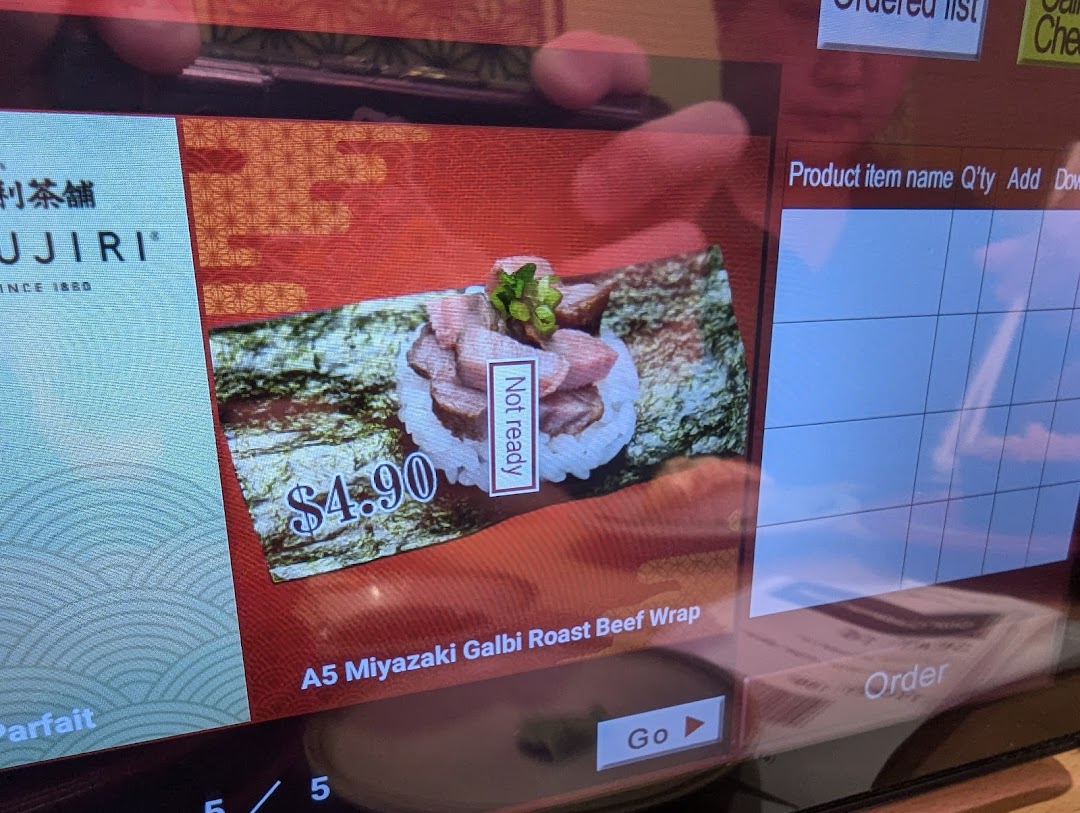 A digital menu screen showing a roast beef wrap item and price.