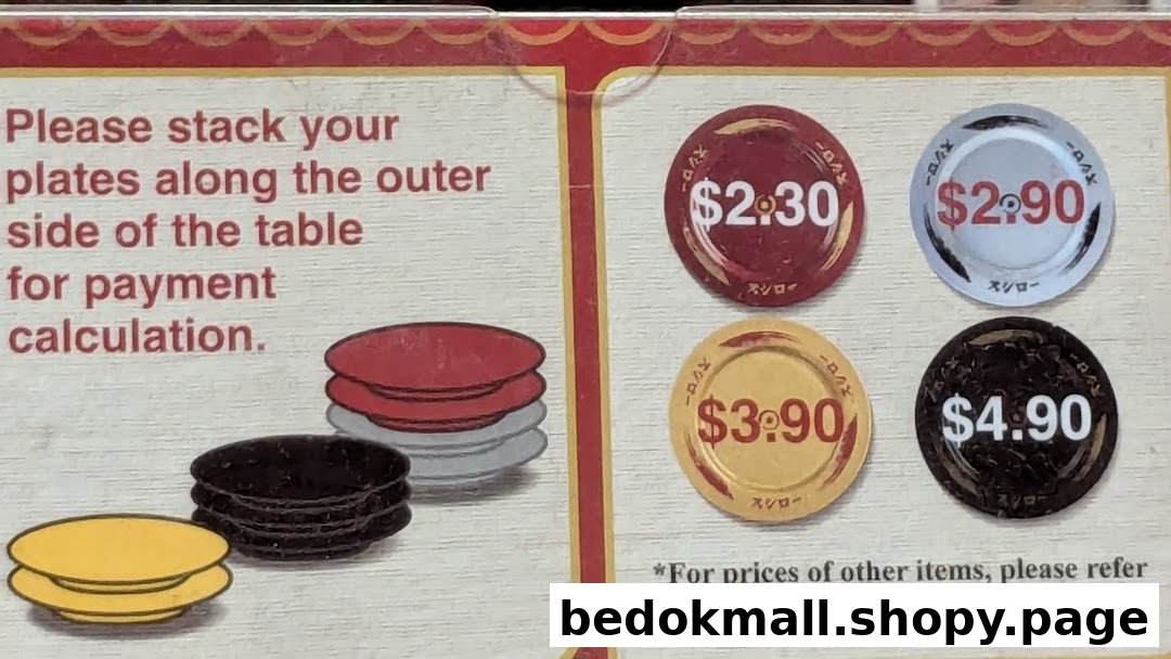 Sign showing plate stacking instructions and prices for different colored sushi plates.