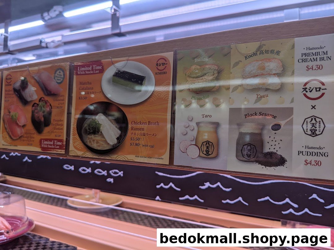 Menu panels showing sushi, ramen, desserts, and prices above a conveyor belt.