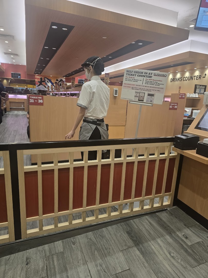 Interior view of a Sushiro restaurant with staff and a self-check-in counter.