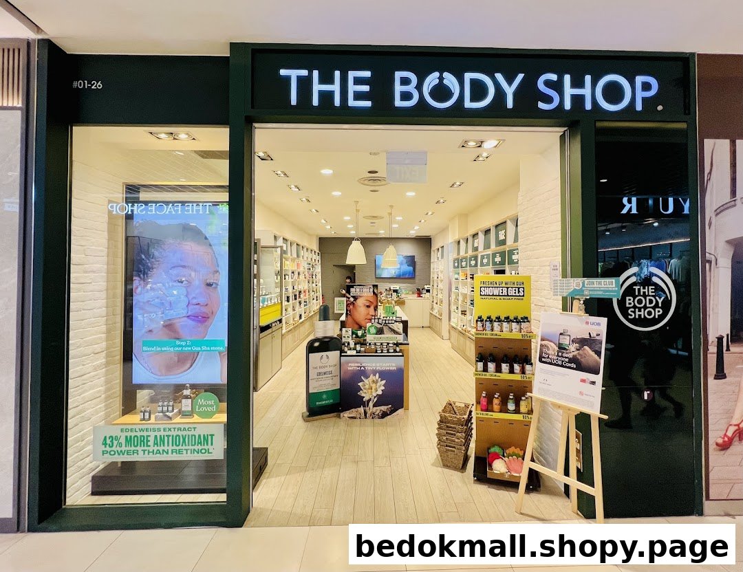 Exterior view of The Body Shop entrance with display windows and interior visible.
