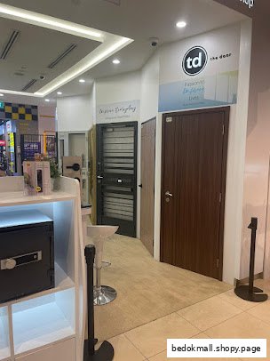 Interior view of a door showroom displaying various types of doors.