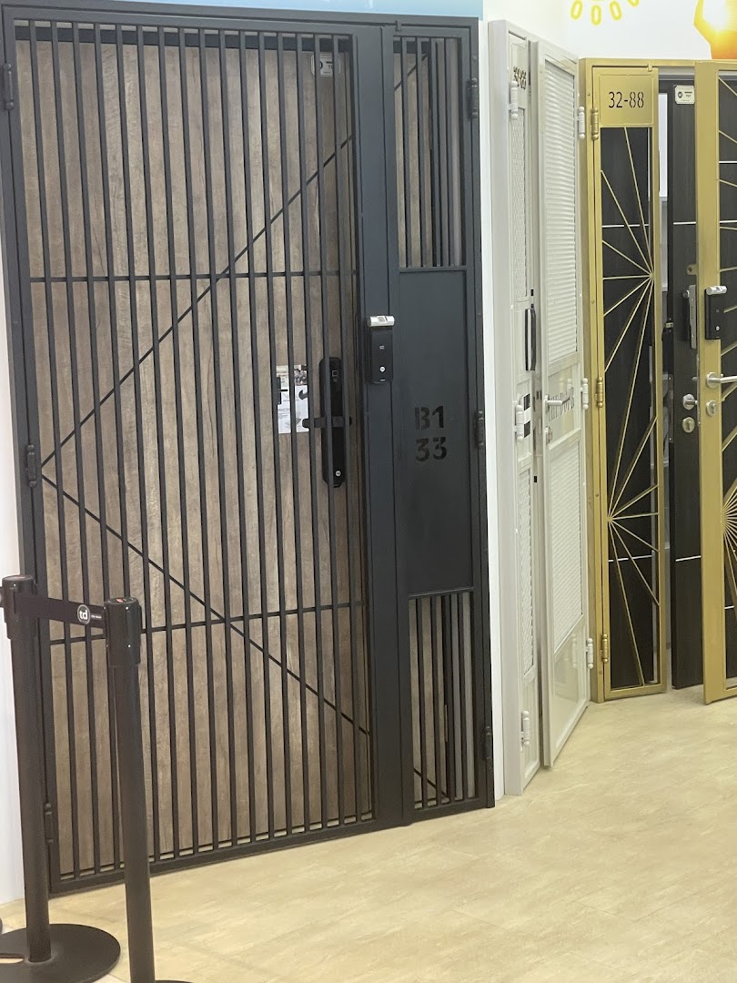 Multiple security gates and doors displayed in a showroom setting.
