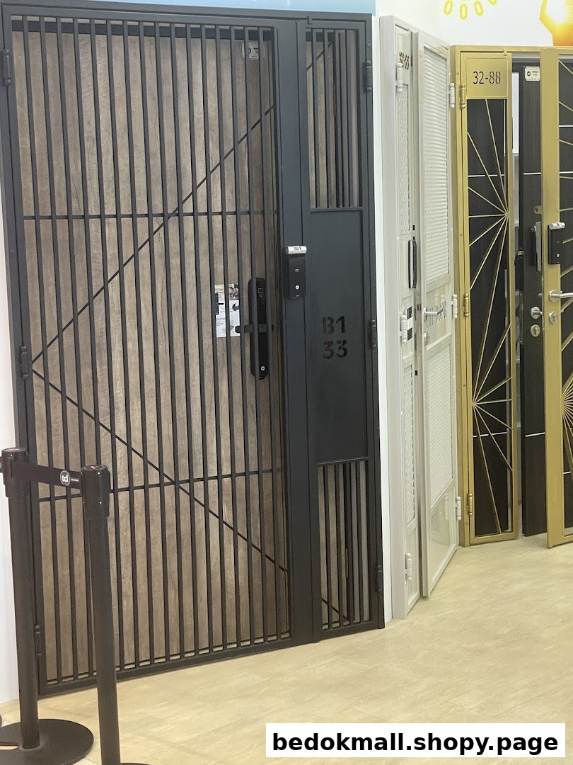 Multiple security gates and doors displayed in a showroom setting.