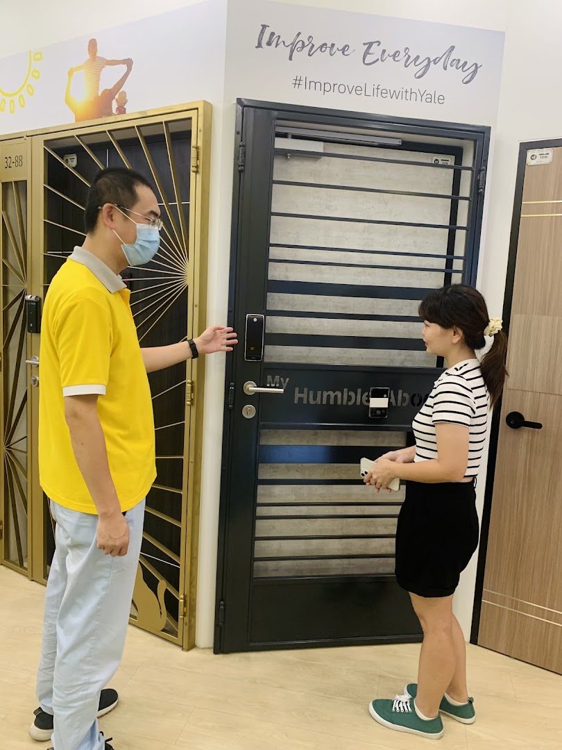 Two people in a door showroom, looking at displayed doors.