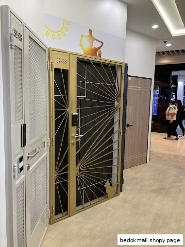 Showroom displaying various security doors, including a gold one with a cat.