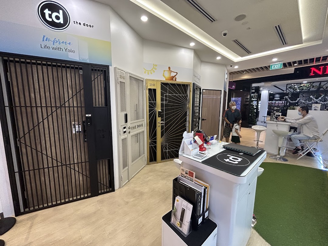 Interior view of a shop displaying various security doors and gates.