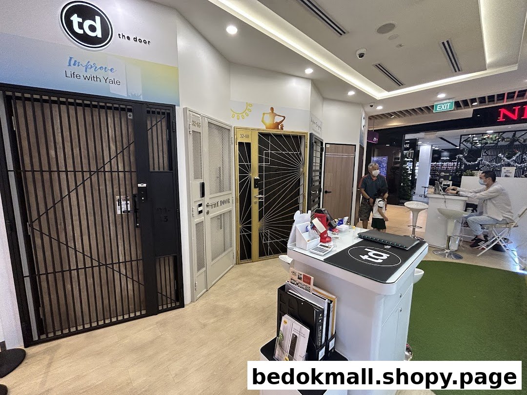 Interior view of a shop displaying various security doors and gates.