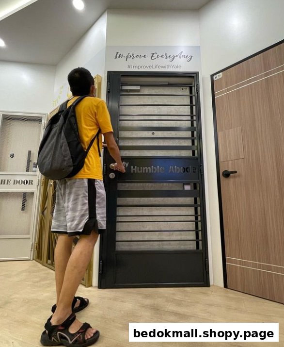 A person examines a display door inside a door showroom.
