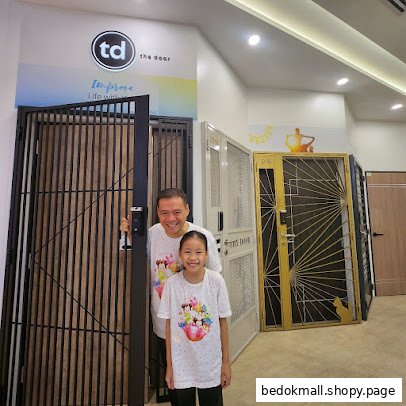 Interior shot of a door showroom with two smiling people.