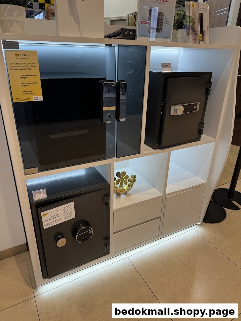 Display stand with Yale smart locks and safes in a retail store.