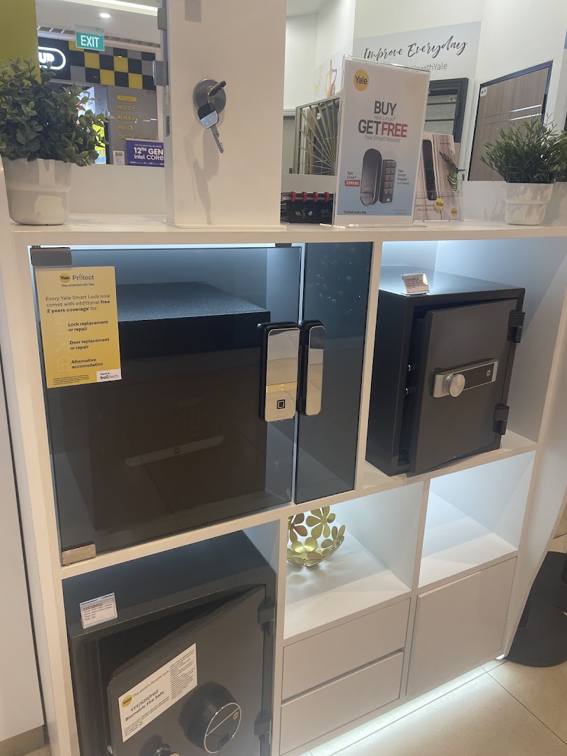 Interior display of Yale smart locks and safes on white shelves.