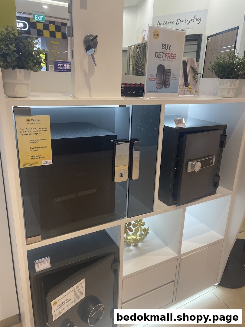 Interior display of Yale smart locks and safes on white shelves.