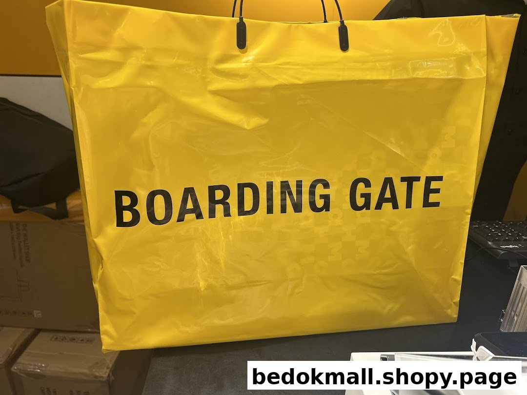 A large yellow shopping bag with 'BOARDING GATE' text on a counter.