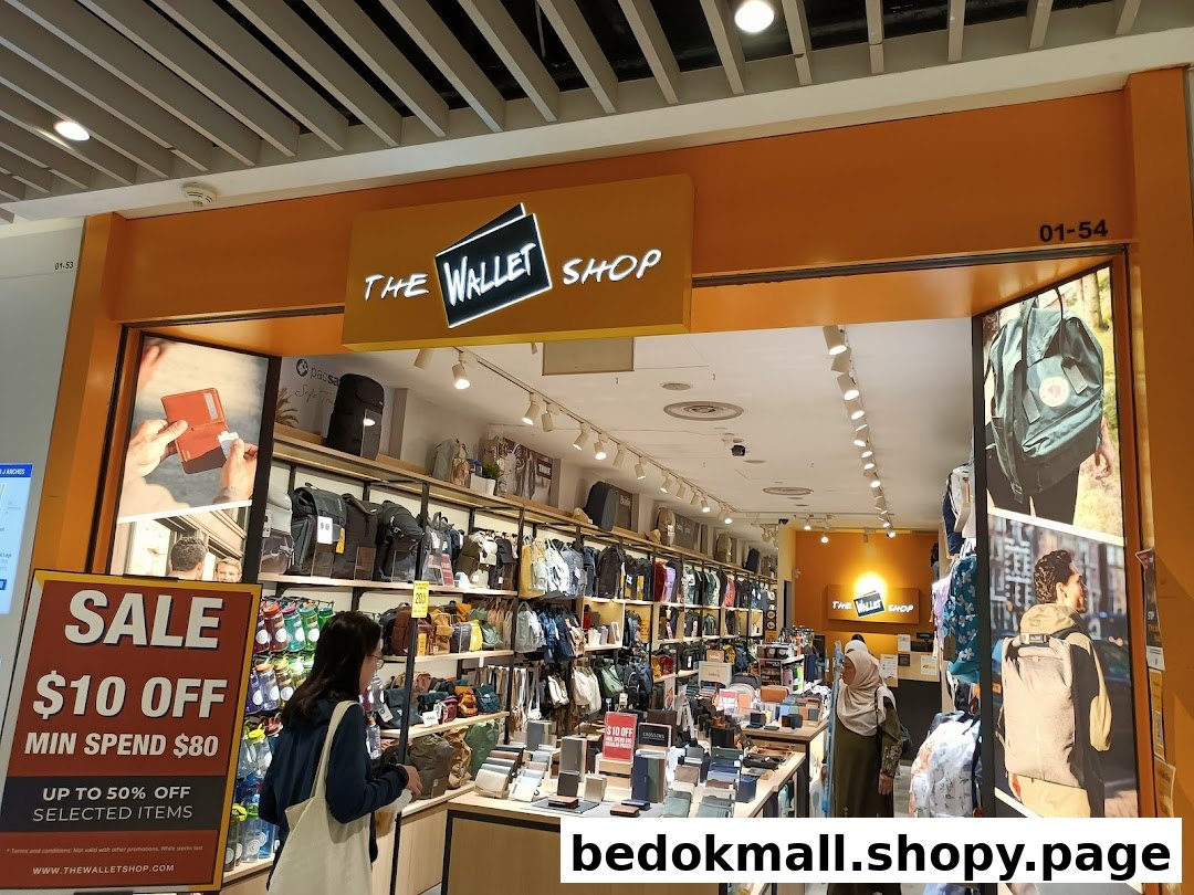 Shop entrance with products displayed and customers inside, featuring a sale sign.
