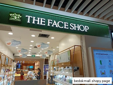 Exterior view of THE FACE SHOP entrance with prominent green signage.
