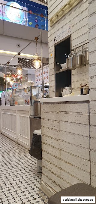 Interior view of a shop counter with display cases and tiled floor.
