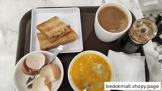 A tray with toast, coffee, and soft-boiled eggs.