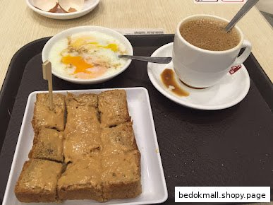 A tray with toast, soft-boiled eggs, and a cup of coffee.
