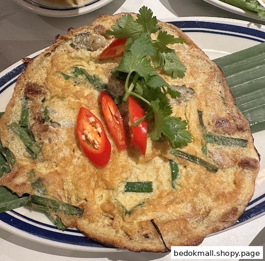 Golden omelet with green onions, chili slices, and cilantro garnish.