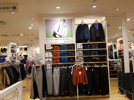 Clothing displays and merchandise inside a UNIQLO retail store.