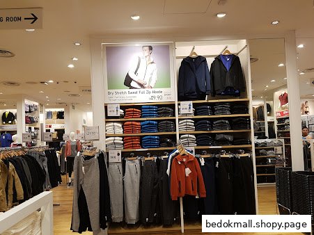 Clothing displays and merchandise inside a UNIQLO retail store.