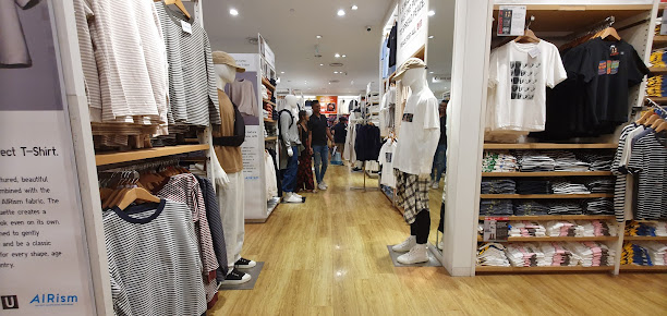 Interior view of a UNIQLO clothing store with mannequins and apparel displays.