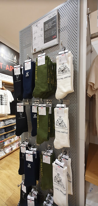 Interior view of a UNIQLO store displaying socks and other clothing items.