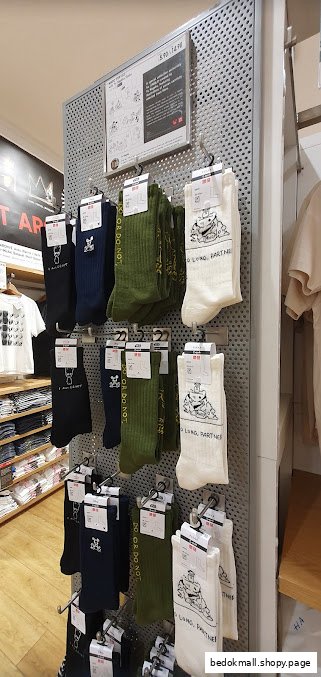 Interior view of a UNIQLO store displaying socks and other clothing items.