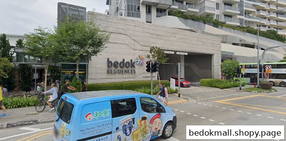 Exterior view of Bedok Residences building and a busy street with vehicles and pedestrians.