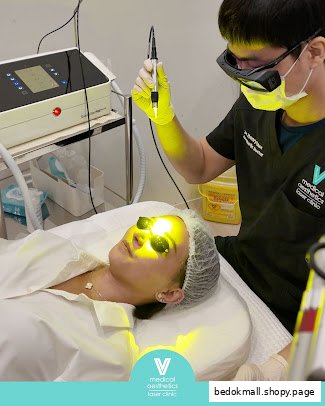 A person receives a laser facial treatment from a practitioner in a clinic.