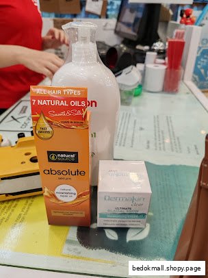 Hair serum and moisturizer products on a shop counter.