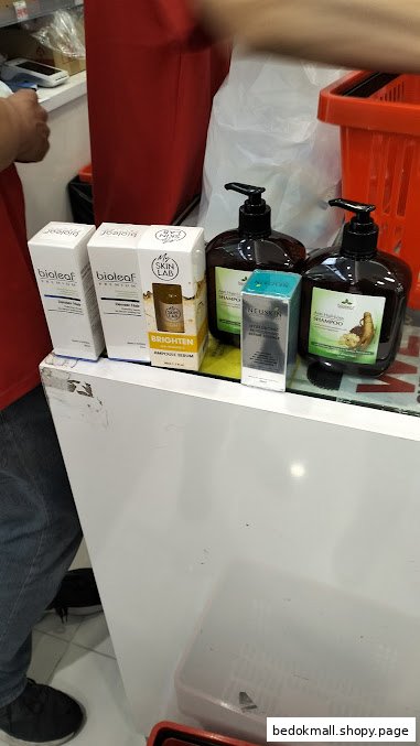 Various beauty products, including shampoos and serums, displayed on a shop counter.