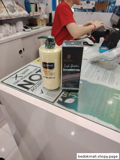 Products on a counter with a staff member at the register.