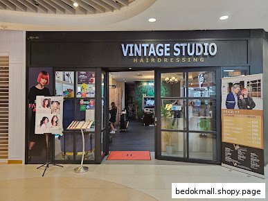 Exterior view of Vintage Studio Hairdressing salon entrance with displays.